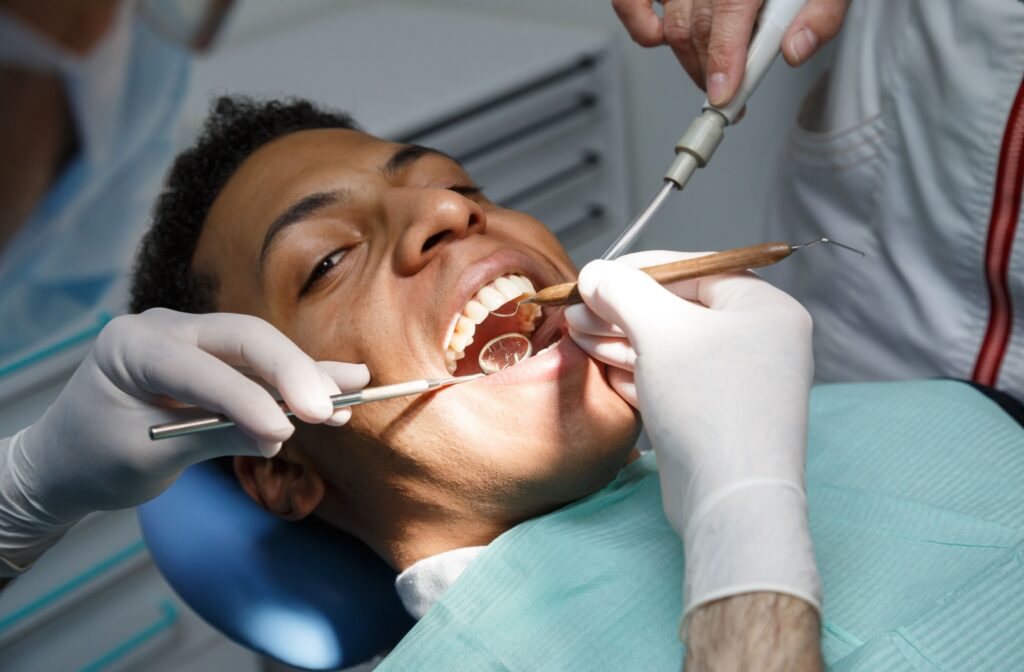 A patient in the exam chair for a routine dental cleaning.