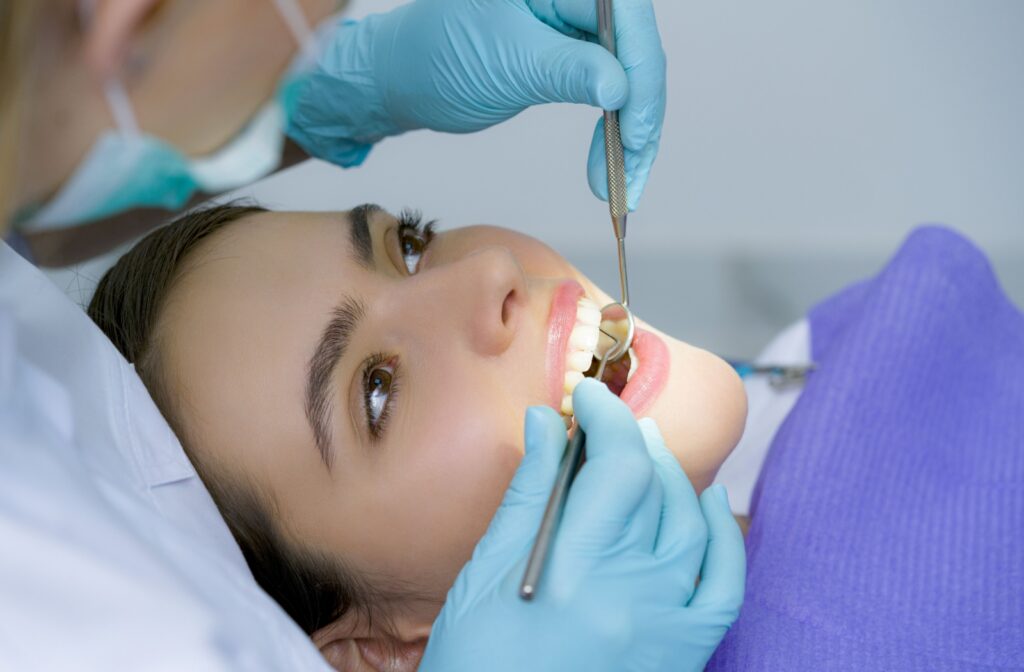 A close up of a patient having their teeth cleaned by a dental hygienist