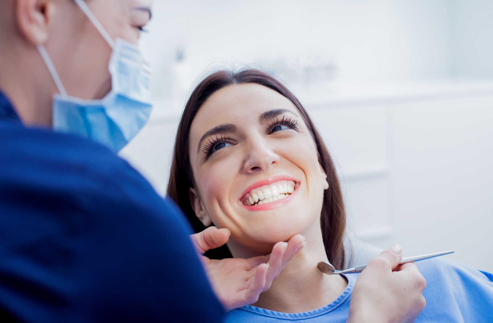 A patient smiling at their dental professional during a dental recall exam.
